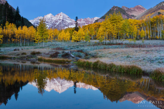Reflections of Maroon Bells in a small pond in Snowmass Wilderness, Colorado by Jay Patel