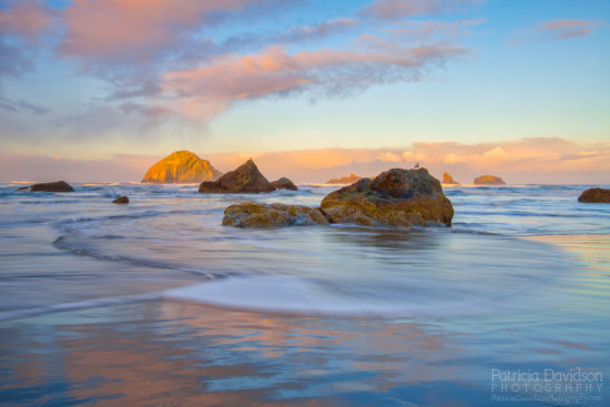 Morning light on the beach in Bandon with Face Rock in the background.