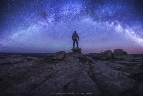 A self portrait of Peter Coskun under the milky way galaxy
